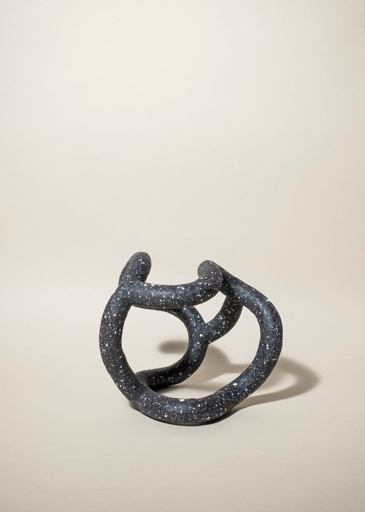 Emeli Höcks "Dice" is an abstract, black sculpture with white specks, made with sustainable materials
